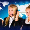 3 women wearing headsets in a call center world map in the background
